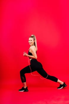 Middle aged woman doing fitness workout, standing on activewear with abs and muscles, smiling happy