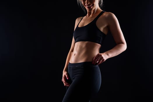 Middle aged woman doing fitness workout, standing on activewear with abs and muscles, smiling happy