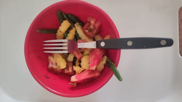 red bowl, fork chips food dinner. High quality photo