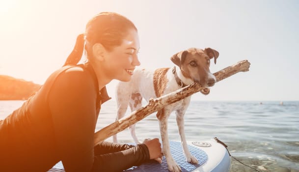 Sea woman sup. A happy positive woman in hat with family relaxing in sea, aerial back view of family on SUP board floating on calm water. Active lifestyle at sea. Summer vacation. Slow motion