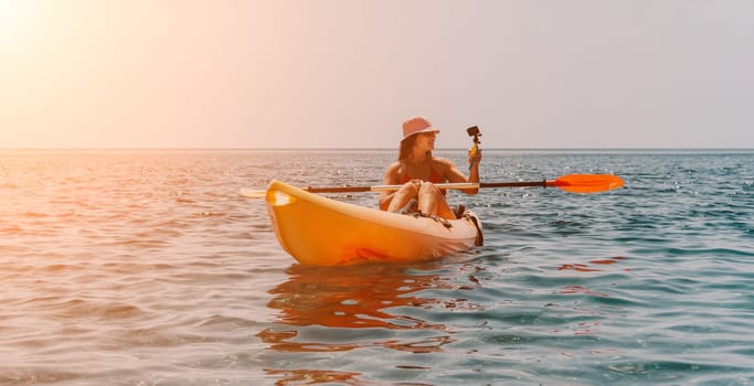 Happy smiling woman in kayak on ocean, paddling with wooden oar. Calm sea water and horizon in background