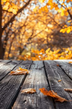 Wooden table in the autumn park. Selective focus. Nature.