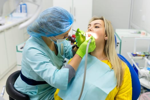 Dental health concept. female mouth on treatment in a dental clinic