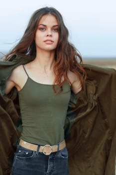 empowered woman with outstretched arms standing in vast desert landscape