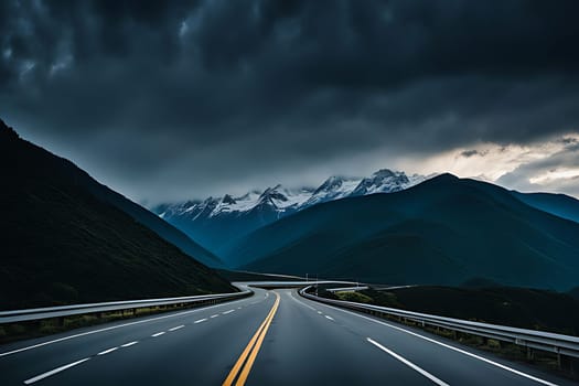 A highway stretches across the image with towering mountains in the background. The sky is overcast with clouds, casting shadows over the landscape.