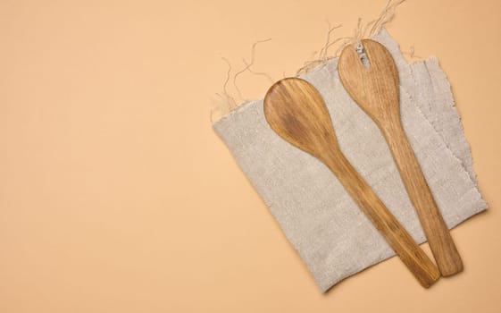 Empty wooden vintage fork and spoon with long handle, top view. Copy space