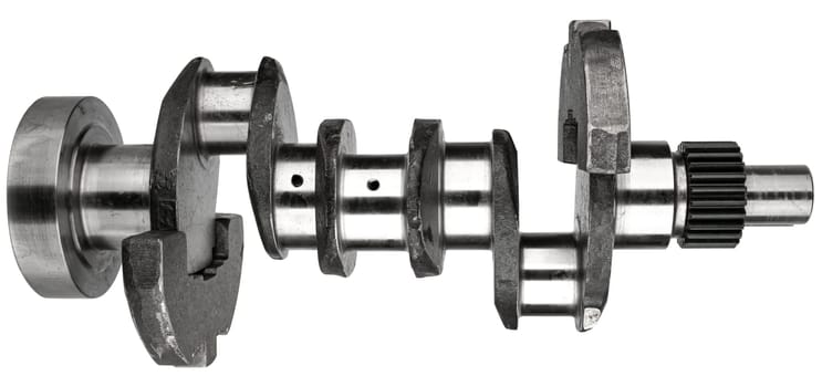 Crankshaft, spare part from car engine on white background in insulation