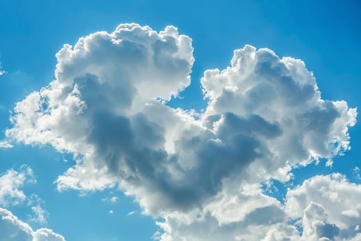 A heart-shaped cloud floating in a clear blue sky.