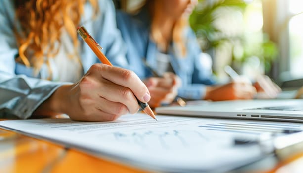 A woman is focused while holding a pencil and writing on a piece of paper, emphasizing the act of handwriting