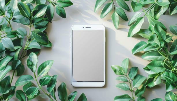 A cell phone surrounded by vibrant greenery rests on a table in a natural environment, blending technology with nature