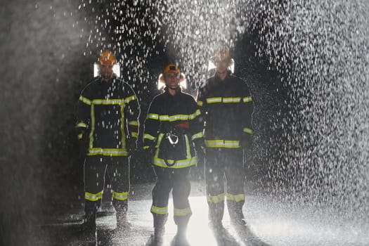 A group of professional firefighters marching through the rainy night on a rescue mission, their determined strides and fearless expressions reflecting their unwavering bravery and unwavering commitment to saving lives