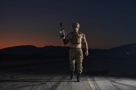 A professional soldier in full military gear striding through the dark night as he embarks on a perilous military mission.