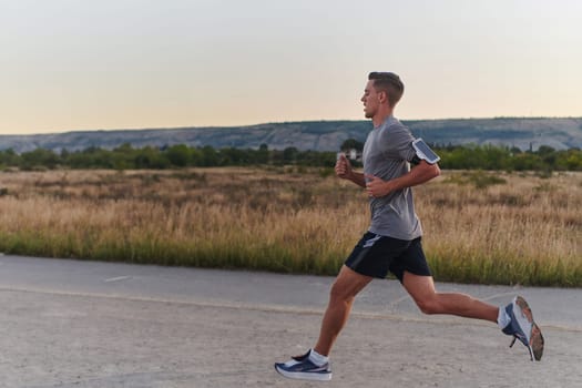 A young handsome man running in the early morning hours, driven by his commitment to health and fitness. High quality photo