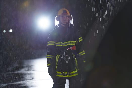 A determined female firefighter in a professional uniform striding through the dangerous, rainy night on a daring rescue mission, showcasing her unwavering bravery and commitment to saving lives