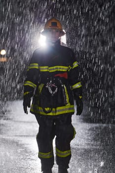 A determined female firefighter in a professional uniform striding through the dangerous, rainy night on a daring rescue mission, showcasing her unwavering bravery and commitment to saving lives