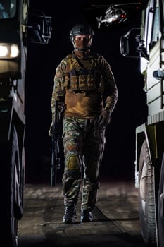 A soldier marching through the dark of night, accompanied by two military trucks, as he embarks on a perilous military mission, embodying the unwavering determination, teamwork, and preparedness required for a covert operation in the face of danger and adversity.