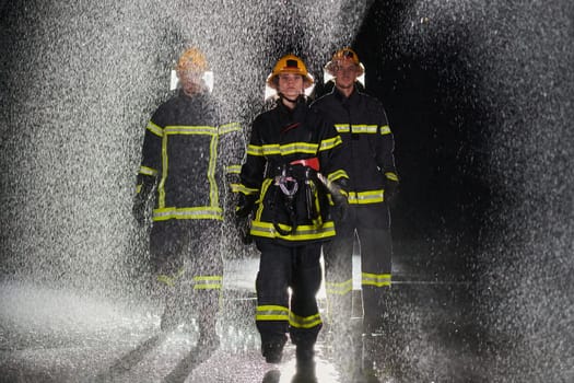 A group of professional firefighters marching through the rainy night on a rescue mission, their determined strides and fearless expressions reflecting their unwavering bravery and unwavering commitment to saving lives