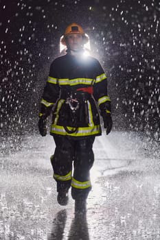 A determined female firefighter in a professional uniform striding through the dangerous, rainy night on a daring rescue mission, showcasing her unwavering bravery and commitment to saving lives