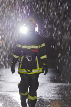 A determined female firefighter in a professional uniform striding through the dangerous, rainy night on a daring rescue mission, showcasing her unwavering bravery and commitment to saving lives