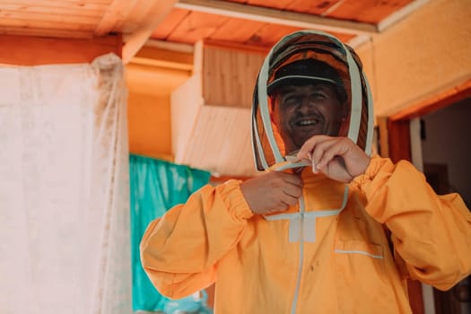 Beekeeper put on a protective beekeeping suit and preparing to enter the apiary.