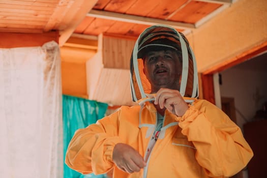 Beekeeper put on a protective beekeeping suit and preparing to enter the apiary.