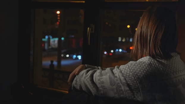 Woman with depression looks out window of house. Media. Woman with anxiety disorder sits on horse and is sad. Woman in sweater sits alone on window.