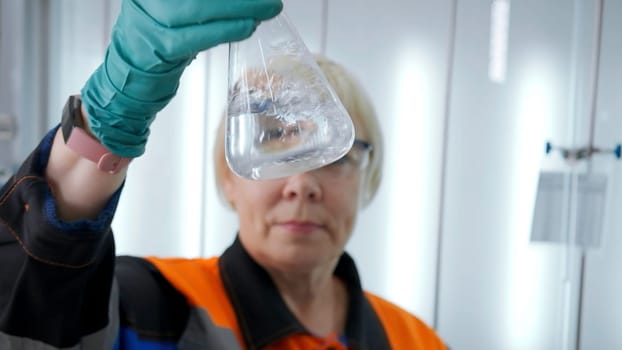 Chemist holding test flask with chemical liquid. Clip. Concept of chemistry and medical science