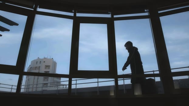 Man carries bag with money. Stock. Man enters terrace of high-rise building with bag. Man delivers bag to customer on terrace of building in summer.