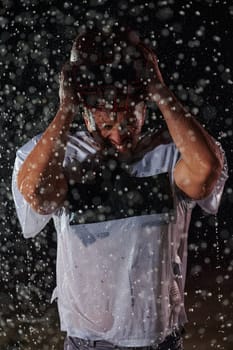 American Football Field: Lonely Athlete Warrior Standing on a Field Holds his Helmet and Ready to Play. Player Preparing to Run, Attack and Score Touchdown. Rainy Night with Dramatic Fog, Blue Light.