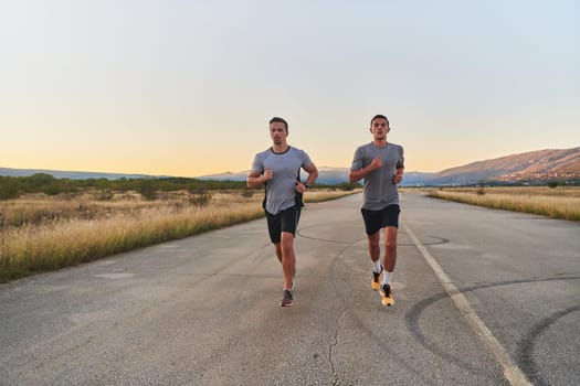 Group of handsome men running together in the early morning glow of the sunrise, embodying the essence of fitness, vitality, and the invigorating joy of embracing nature's tranquility during their refreshing and energizing workout