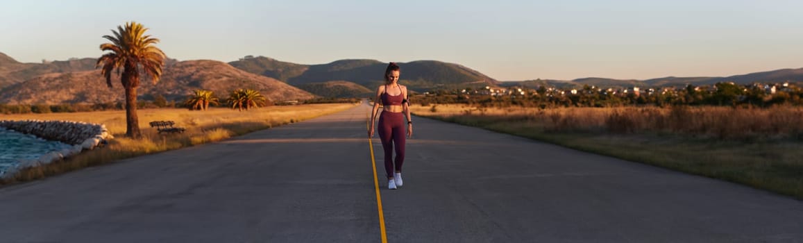 Healthy young couple jogging in the city streets in the early morning with a beautiful sunrise in the background.