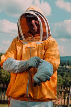 Beekeeper put on a protective beekeeping suit and preparing to enter the apiary.