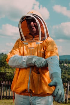 Beekeeper put on a protective beekeeping suit and preparing to enter the apiary.