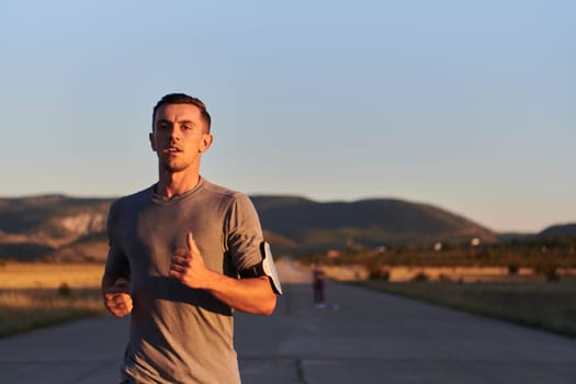 A young handsome man running in the early morning hours, driven by his commitment to health and fitness. High quality photo