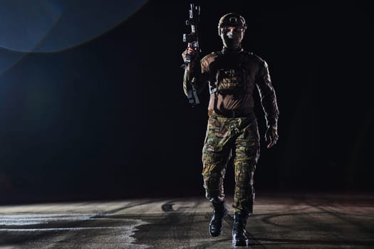 A professional soldier in full military gear striding through the dark night as he embarks on a perilous military mission.