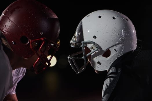 Two american football players face to face in silhouette shadow on white background.