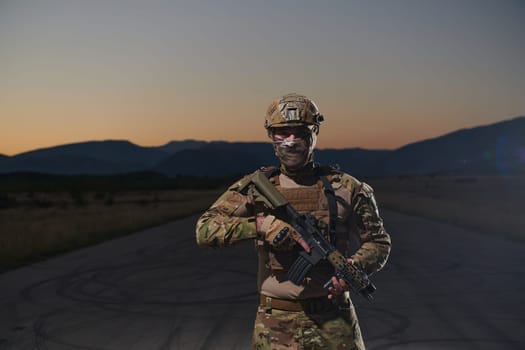 A professional soldier in full military gear striding through the dark night as he embarks on a perilous military mission.