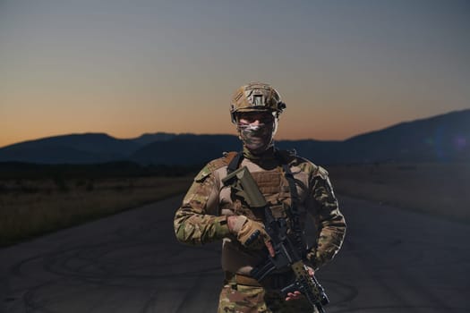 A professional soldier in full military gear striding through the dark night as he embarks on a perilous military mission.