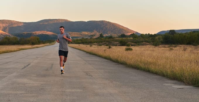 A young handsome man running in the early morning hours, driven by his commitment to health and fitness. High quality photo