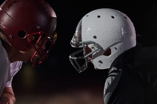 Two american football players face to face in silhouette shadow on white background.