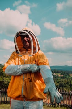 Beekeeper put on a protective beekeeping suit and preparing to enter the apiary.