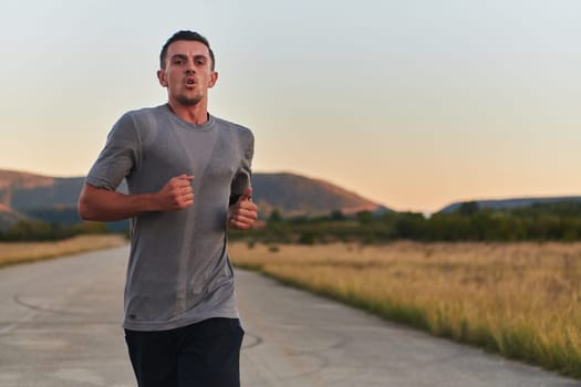 A young handsome man running in the early morning hours, driven by his commitment to health and fitness. High quality photo