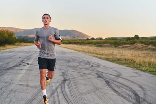 A young handsome man running in the early morning hours, driven by his commitment to health and fitness. High quality photo