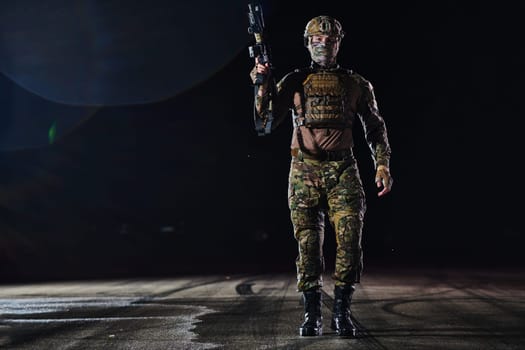 A professional soldier in full military gear striding through the dark night as he embarks on a perilous military mission.