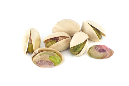 Pistachios in-shell and others peeled exposing the green nuts inside isolated on white background