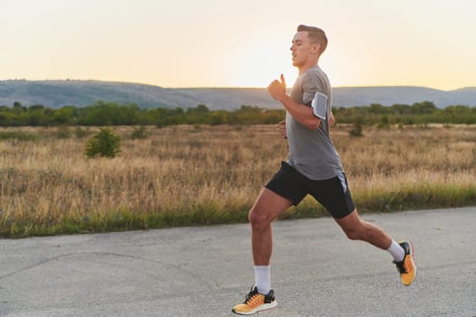 A young handsome man running in the early morning hours, driven by his commitment to health and fitness. High quality photo