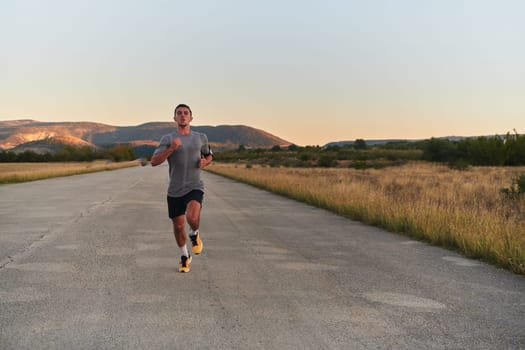 A young handsome man running in the early morning hours, driven by his commitment to health and fitness. High quality photo