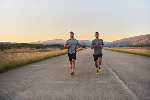 Group of handsome men running together in the early morning glow of the sunrise, embodying the essence of fitness, vitality, and the invigorating joy of embracing nature's tranquility during their refreshing and energizing workout