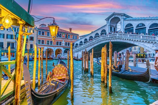 Panoramic view of famous Canal Grande with famous Rialto Bridge at sunset in Venice