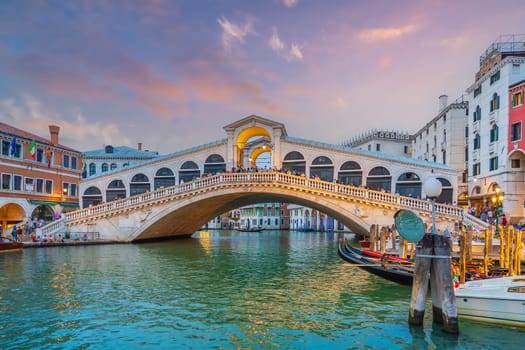 Panoramic view of famous Canal Grande with famous Rialto Bridge at sunset in Venice